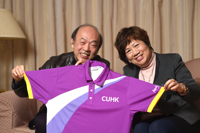 Mr. and Mrs. Sin holding the CUHK sports uniform designed and sponsored by them