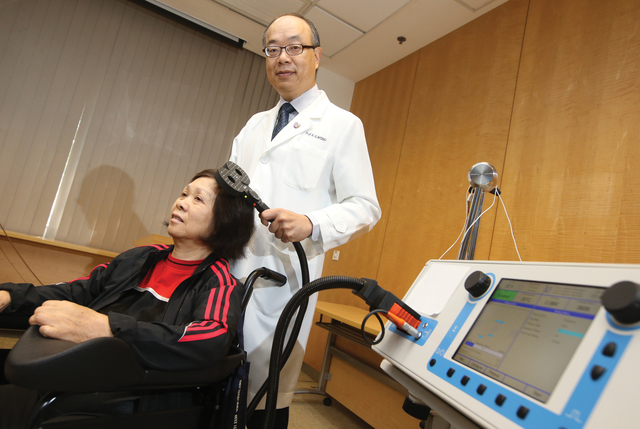 Prof. Lawrence Wong demonstrating iTBS treatment on a stroke patient
