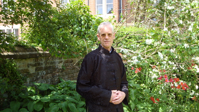 Dressed in cheongsam in his home garden in Oxford