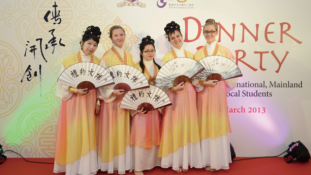 Incoming exchange students perform traditional Chinese fan dance at a dinner party for local and overseas students